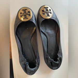 Tori Burch size 7 black flats with gold hardware.